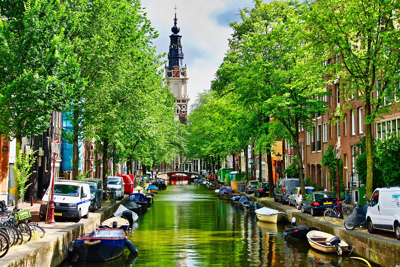 Amsterdam canal with a church tower in view