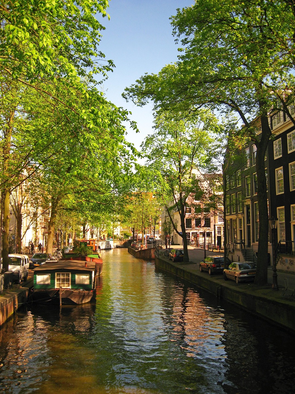 Traditional green houseboat on an Amsterdam canal