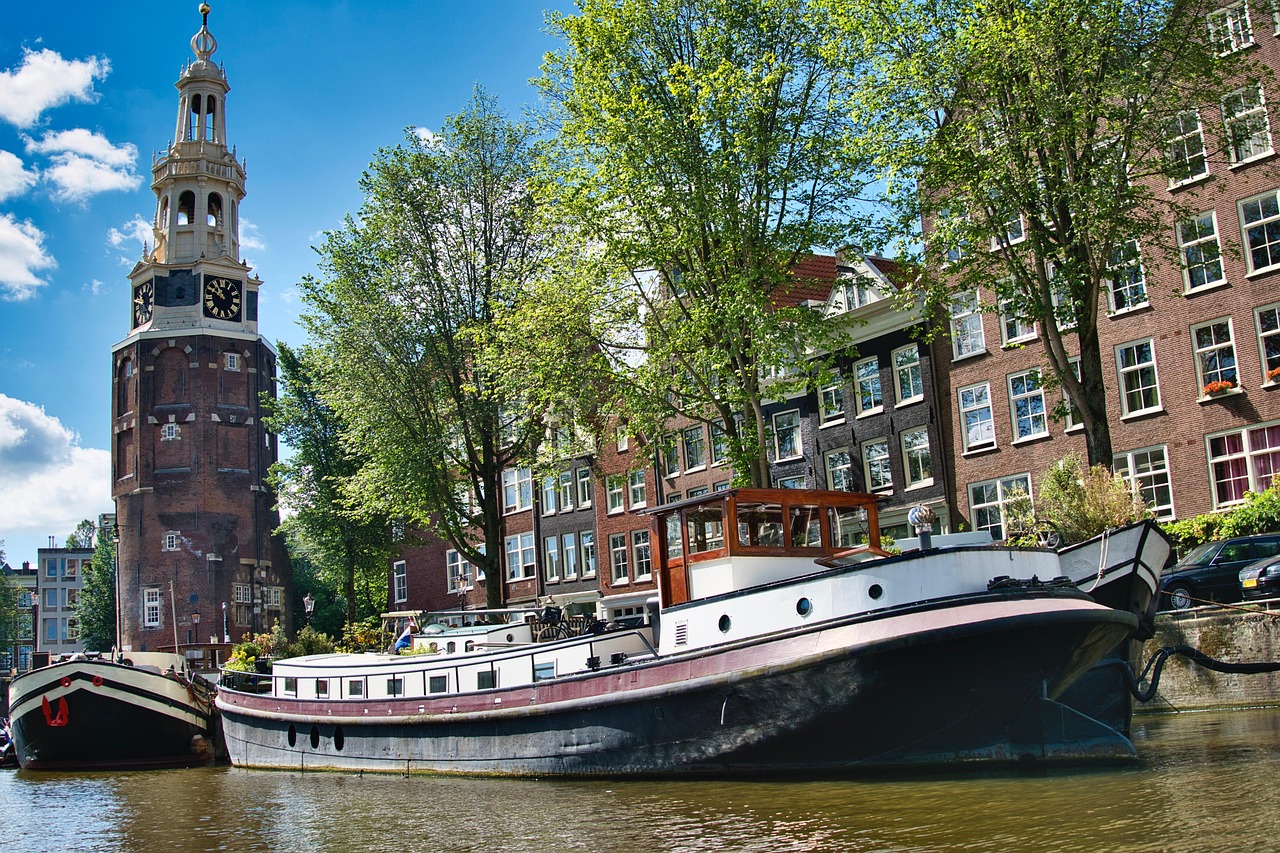 Montelbaanstoren tower above Amsterdam houseboats