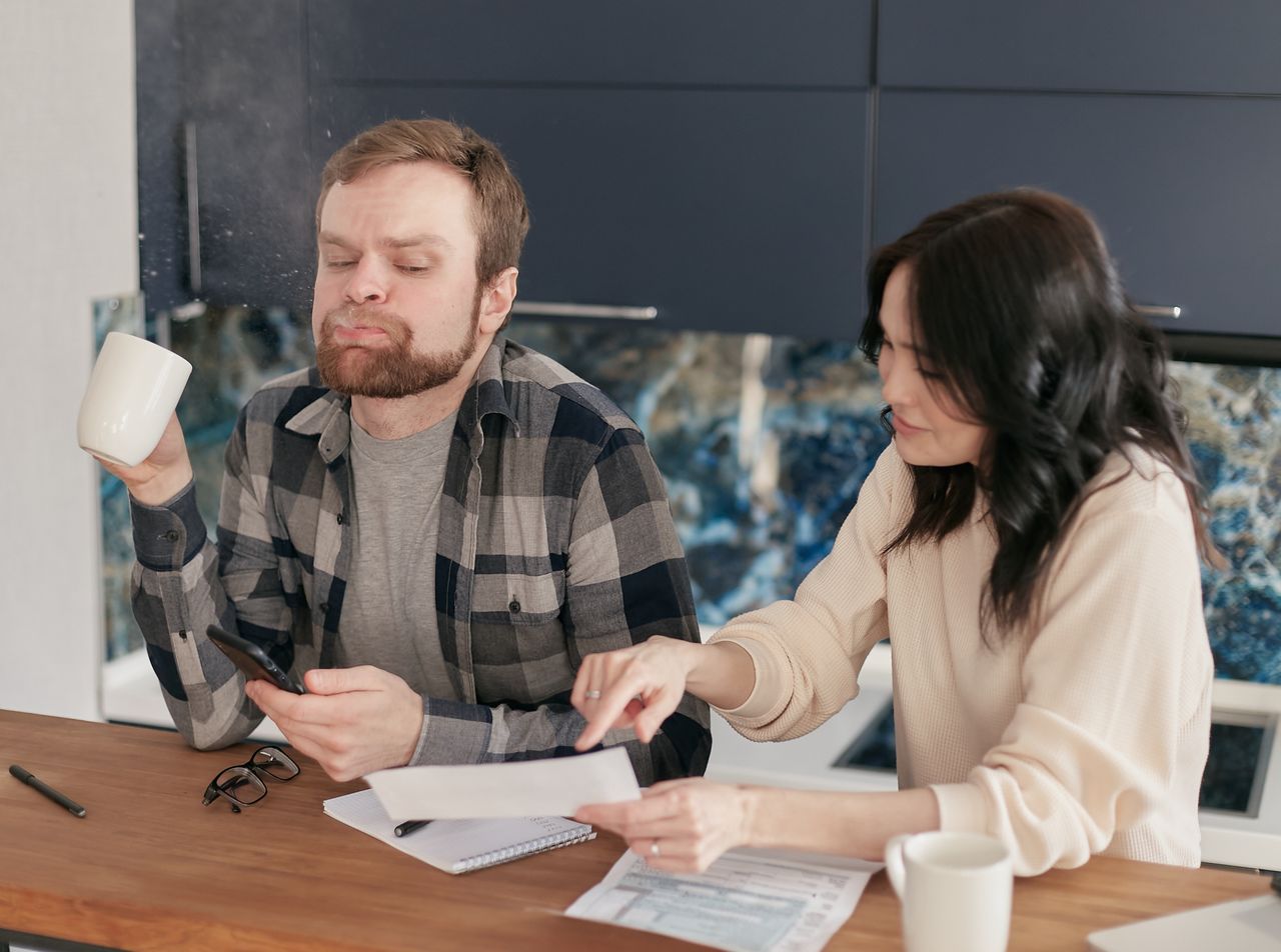 Couple going through bills at the kitchen table