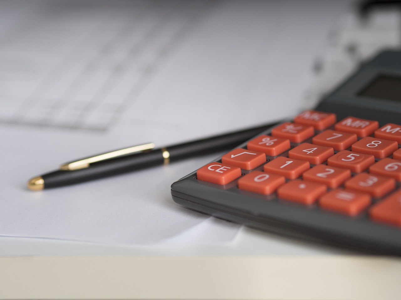 Calculator and pen on a desk