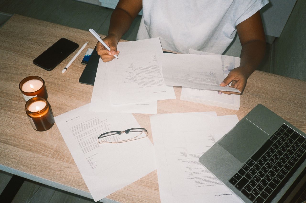 Paperwork, a laptop and a phone on a desk
