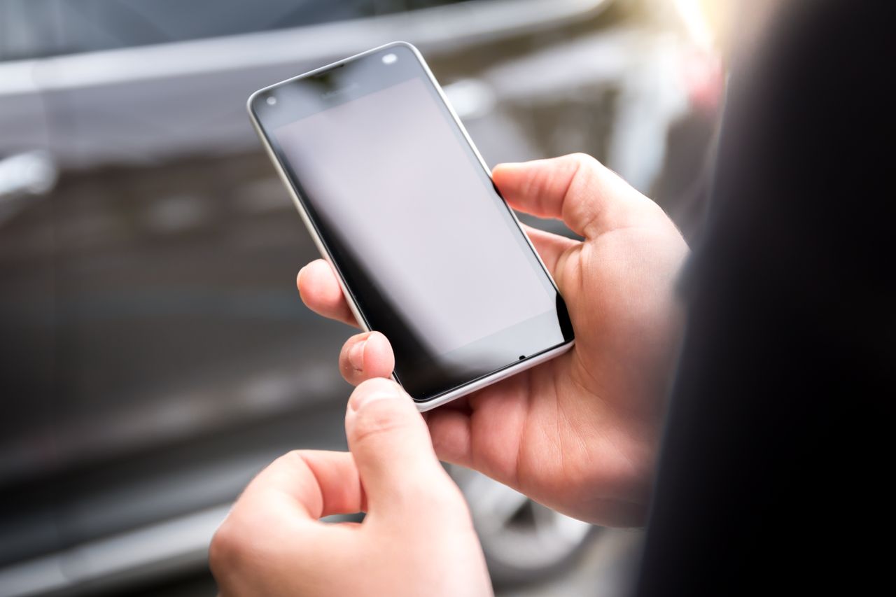 Hands holding a smartphone, ready to log in